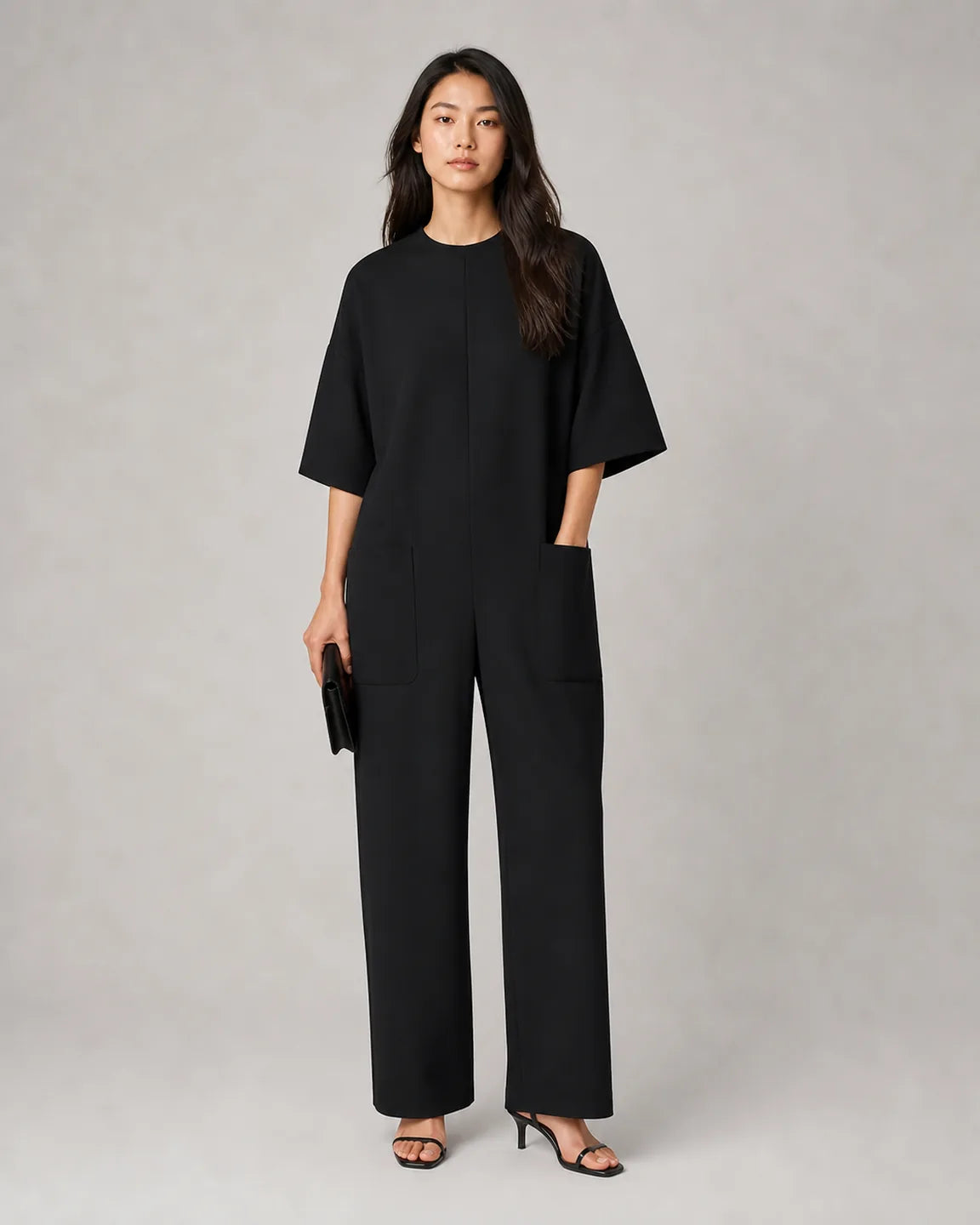 Estelle Elegant Short-Sleeve Jumpsuit in Black — full-body studio view