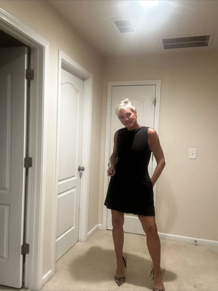 Person in einem ärmellosen schwarzen Minikleid